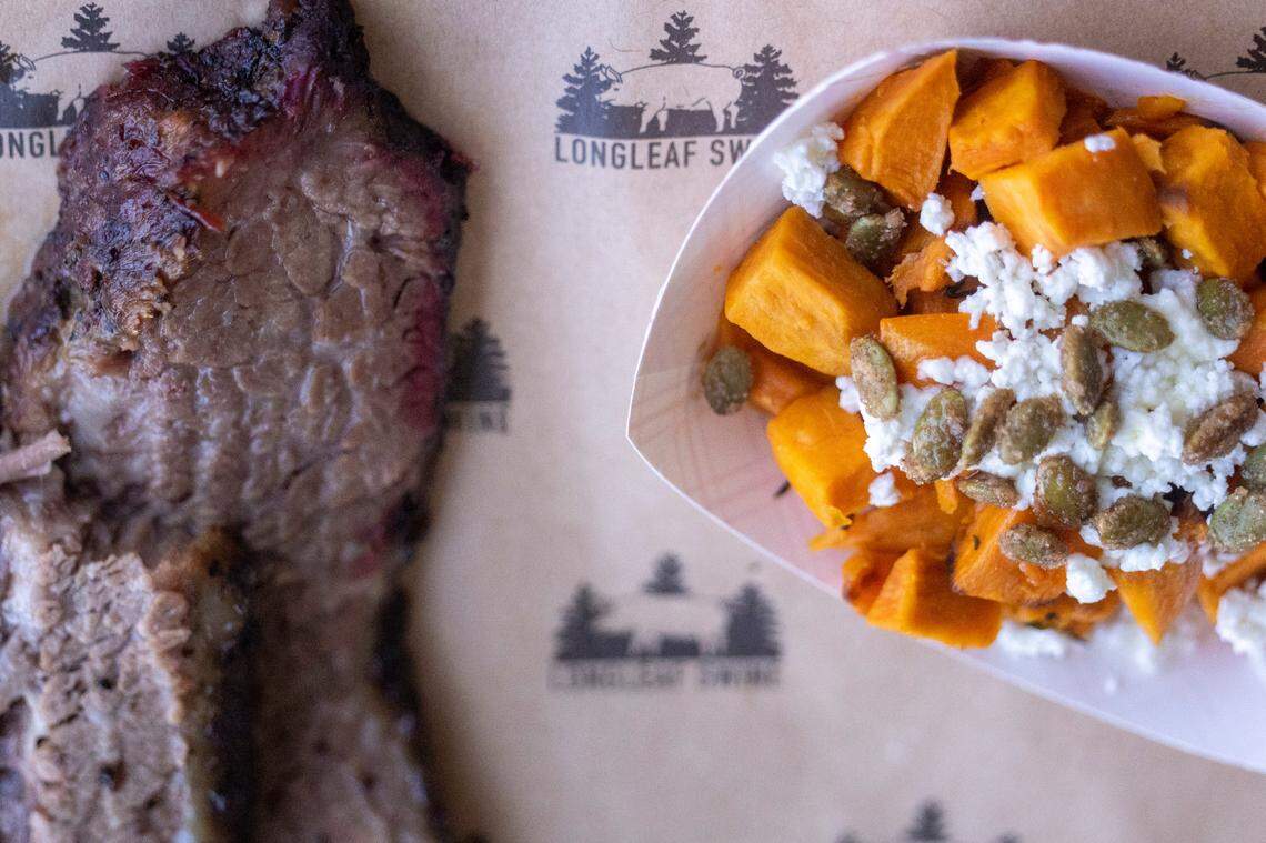 Brisket and sweet potatoes sit on a tray during the opening of Longleaf Swine in Raleigh Friday, Nov. 4, 2022.