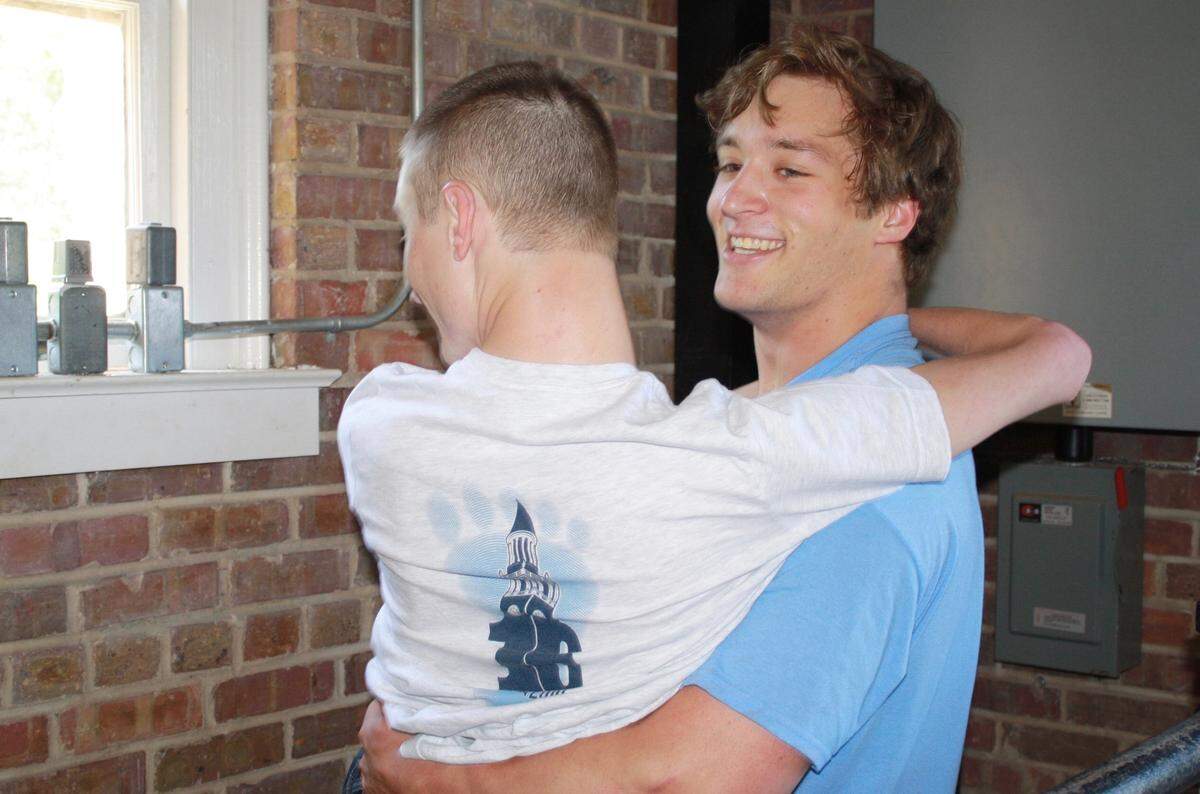 Nathan Staub, a former UNC football player, carries Joe up to the top of the Morehead-Patterson Bell Tower in 2016 to sign his name. Signing your name in the bell tower is a UNC tradition.