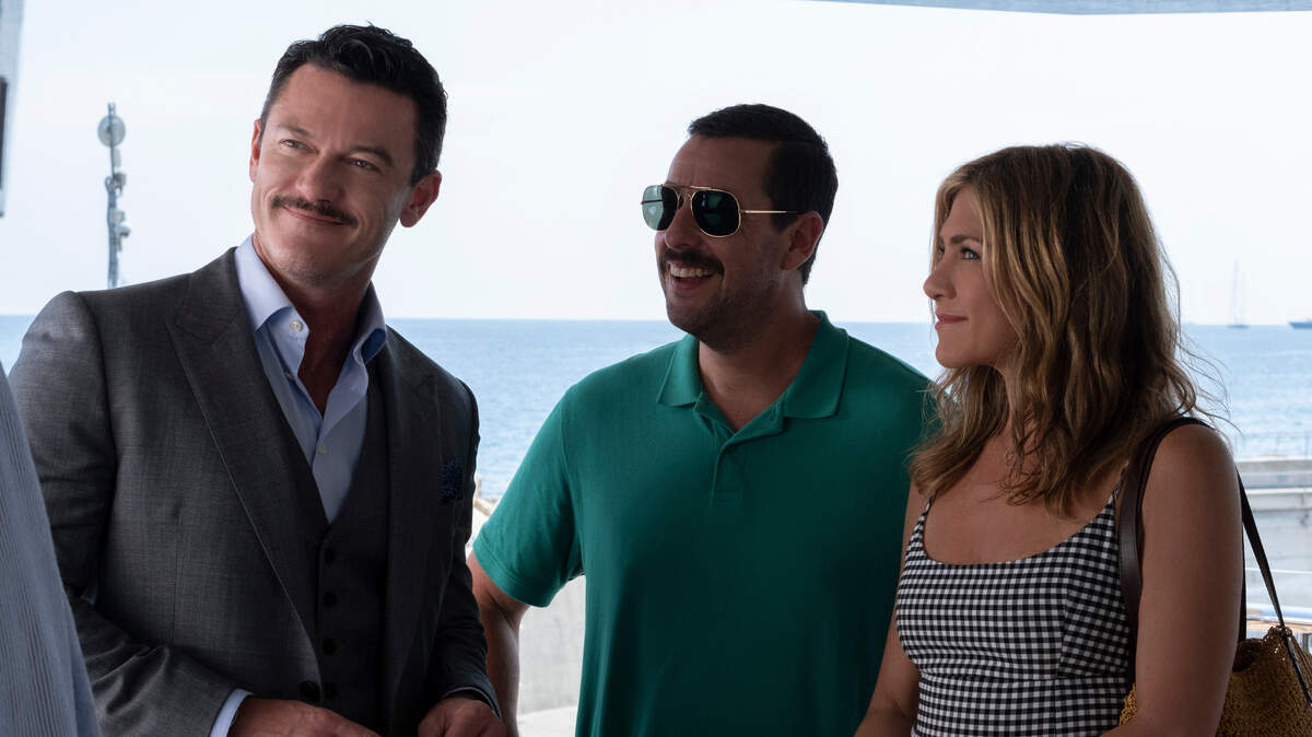 (L-R): Luke Evans as Charles Cavendish, Adam Sandler as Nick Spitz and Jennifer Aniston as Audrey Spitz in the Netflix original movie “Murder Mystery.”