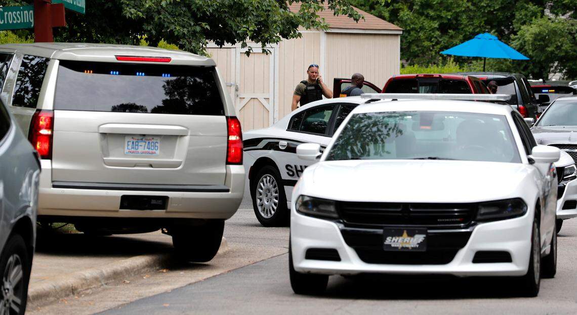 Officials gather at River Birch Apartments on Old Wake Forest Road in Raleigh, N.C., Wednesday, June 2, 2021, after a Wake County sheriff’s deputy was shot during an eviction process, said Wake County Sheriff’s Office spokesperson Eric Curry.