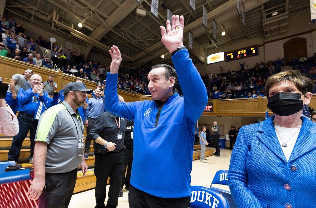 Former Duke head coach Mike Krzyzewski acknowledges the crowd as he gets to his seat before Duke’s game against Notre Dame at Cameron Indoor Stadium in Durham, N.C., Tuesday, Feb. 14, 2023.