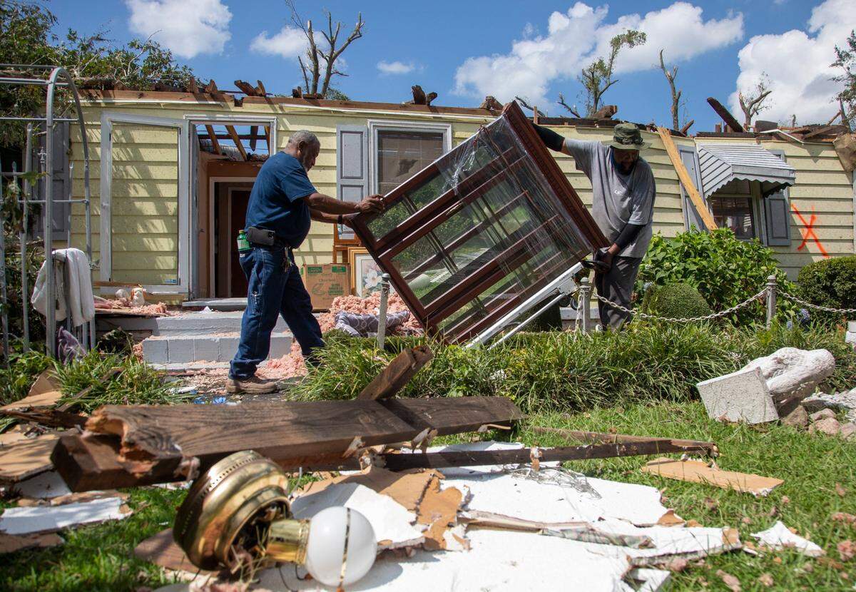 Family members help clean up the home of Evelyn Powell, an Edgecombe County Commissioner, Thursday, July 20, 2023 in Battleboro. An EF3, tornado with wind speeds of 150 mph touched down in Nash and Edgecombe Counties around 12:30 p.m. Wednesday according to the Raleigh National Weather Service.