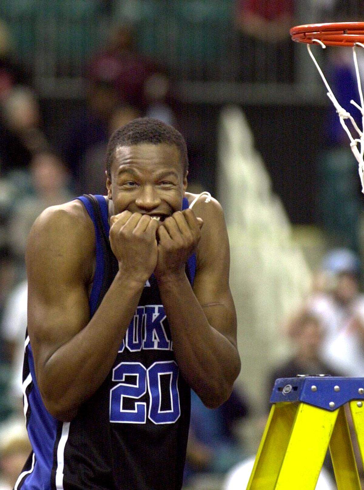 Duke's Casey Sanders flashes the crowd of Duke fans a grin after cutting a string from the net during the Blue Devils' celebration after winning the  2001 ACC Tournament.  Duke defeated UNC 79-53.  
