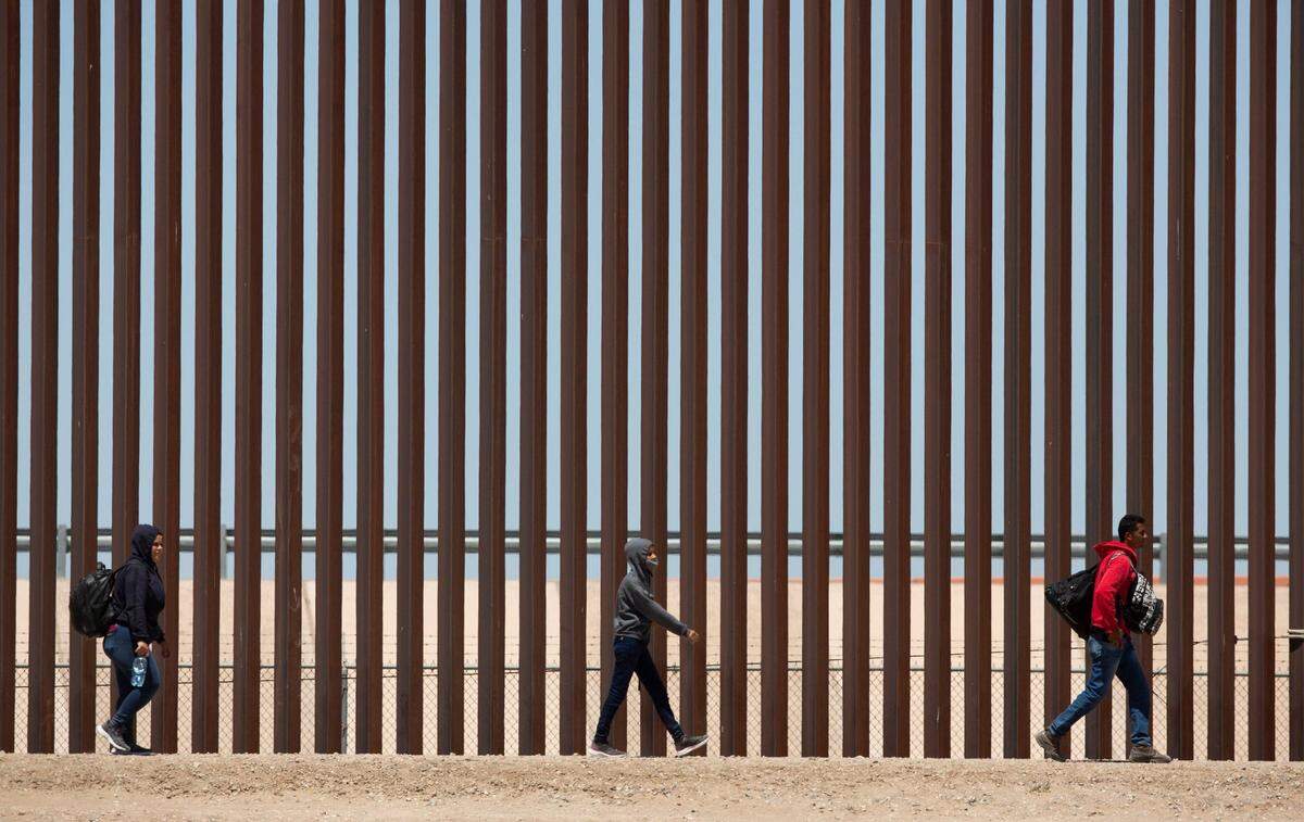Migrants await to be processed at gate 40 of the border wall after having crossed the Rio Grande from Ciudad Juarez in hopes of turning themselves in with the intention of seeking asylum.