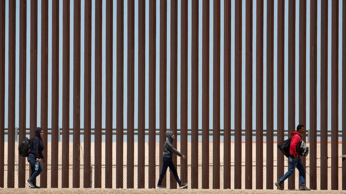 Migrants await to be processed at gate 40 of the border wall after having crossed the Rio Grande from Ciudad Juarez in hopes of turning themselves in with the intention of seeking asylum.