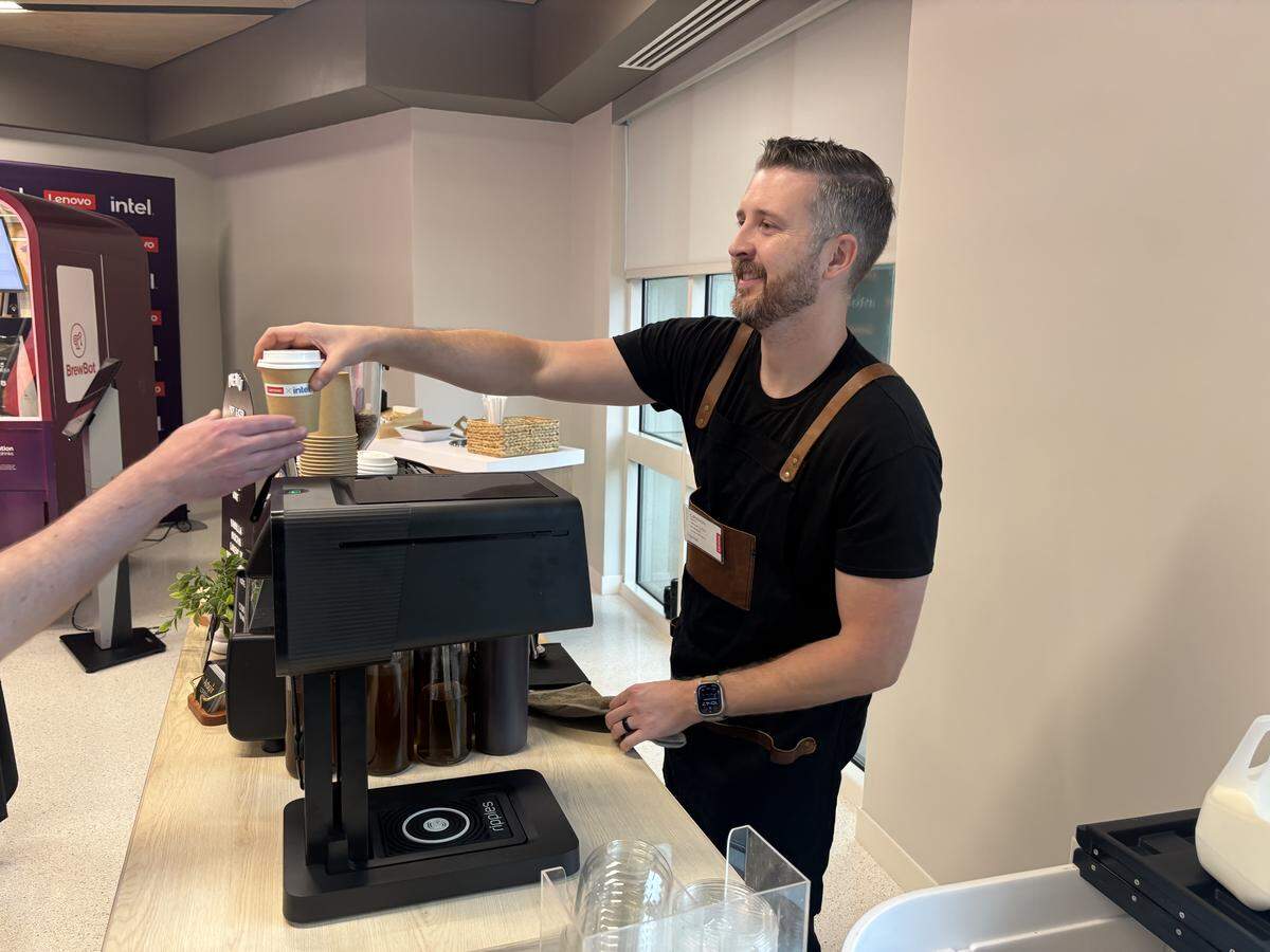 Cameron Keith of Arbour Coffee serves a visitor at Lenovo’s Research Triangle Park campus.