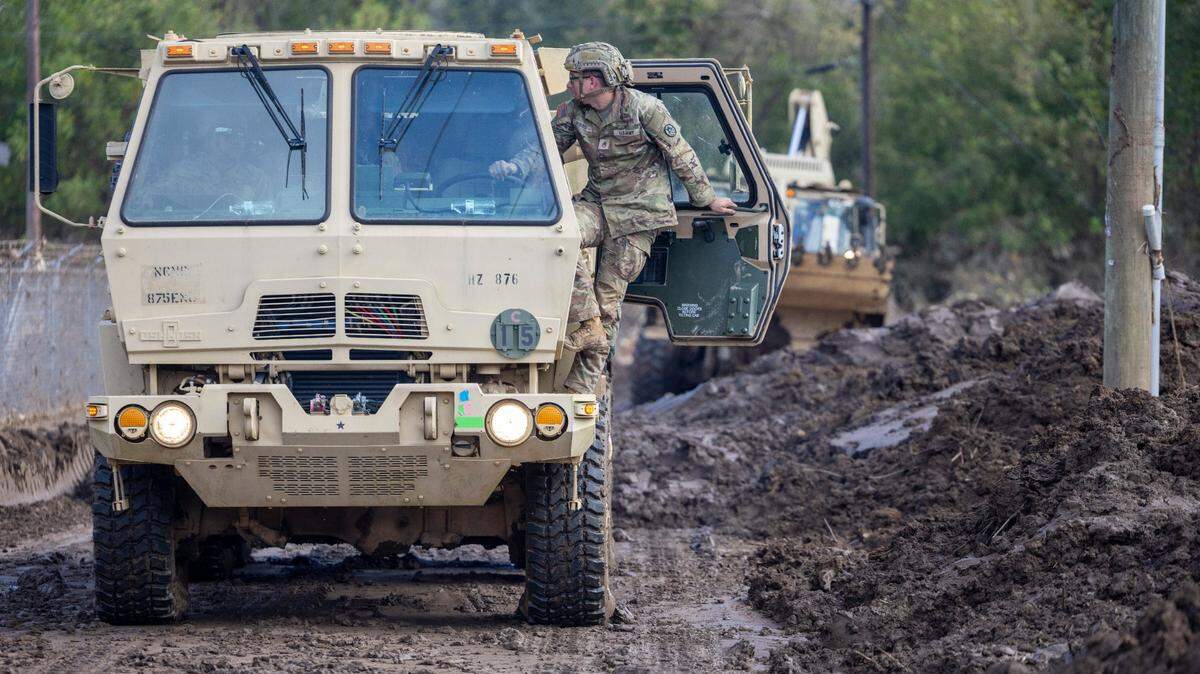 National Guard Troops from Newton and Winston-Salem, N.C. work with local officials to remove more than three feet of mud from the Old Fort Water and Waste Treatment plant on Wednesday, October 2, 2024 in Old Fort, N.C. Heavy rain from Hurricane Helene flooded Curtis Creek, forcing the plant to shut down.
