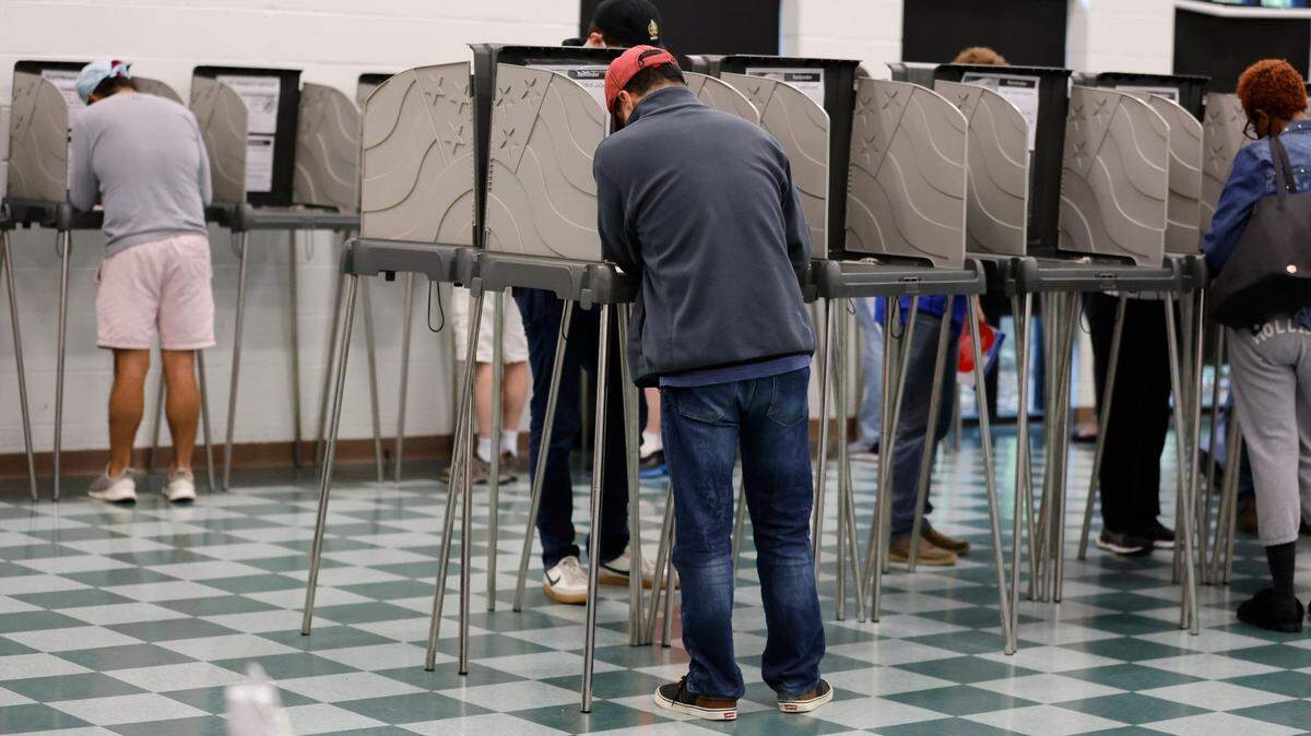 Voters cast their ballot at the early voting site at the Cary Senior Center in Cary, N.C., on Friday, Oct. 28, 2022.