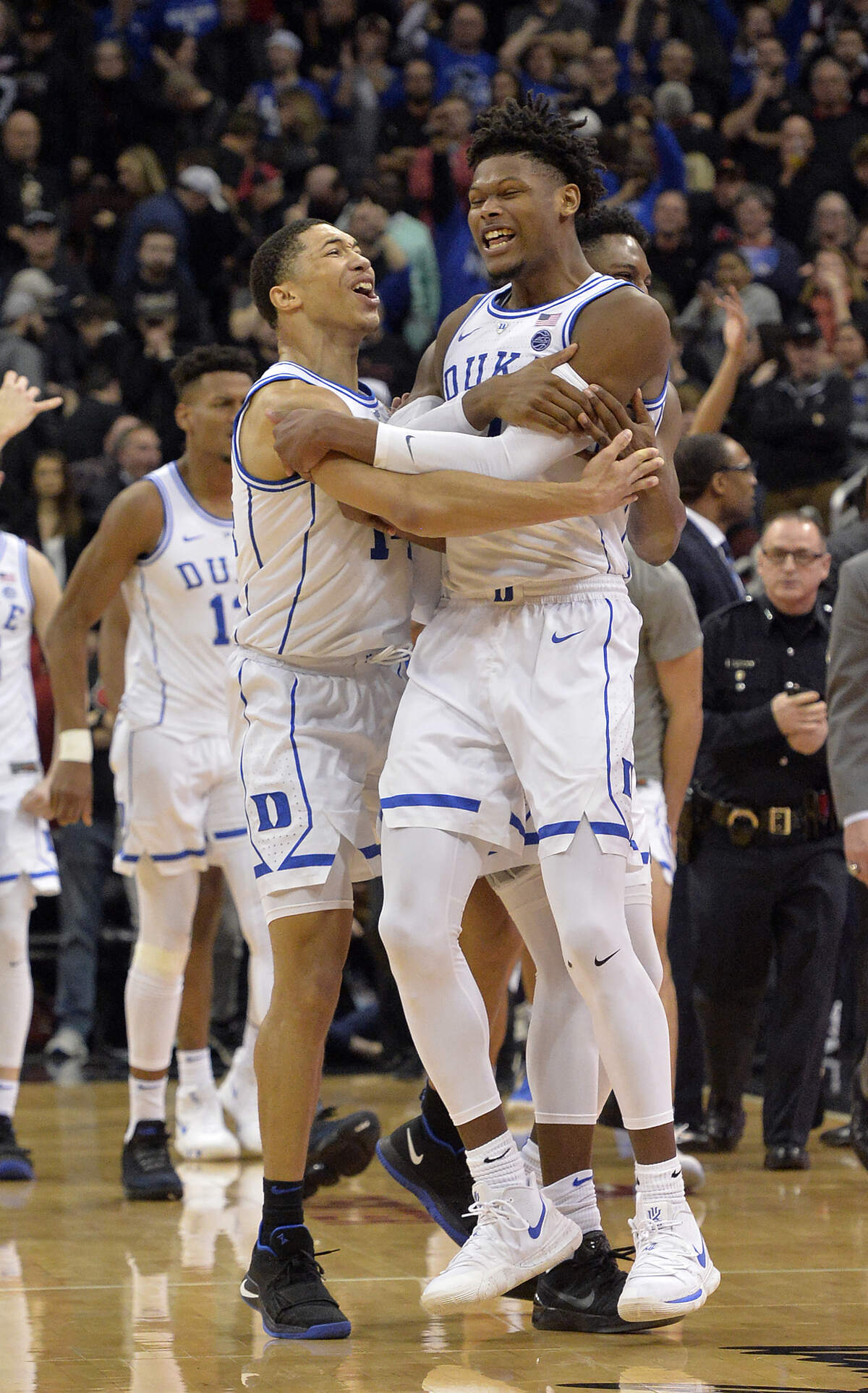 Duke guard Jordan Goldwire, left, and forward Cam Reddish celebrate following the team’s 71-69 victory over Louisville in an NCAA college basketball game in Louisville, Ky., Tuesday, Feb. 12, 2019. (AP Photo/Timothy D. Easley)