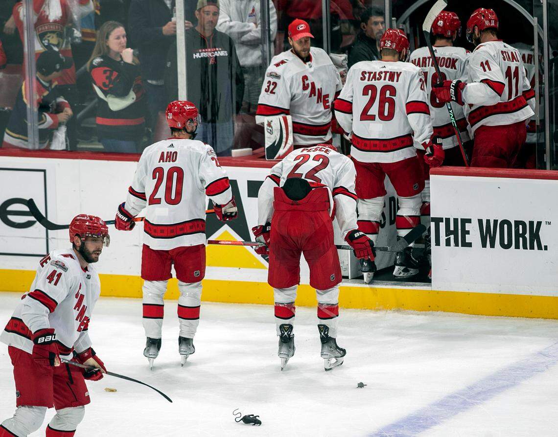 The Carolina Hurricanes Sebastian Aho (20) and Brett Pesce (22) leave the ice with their teammates after falling 1-0 to the Florida Panthers in Game 3 of the Eastern Conference Finals on Monday, May 22, 2023 at FLA Live Arena in Sunrise, Fla.