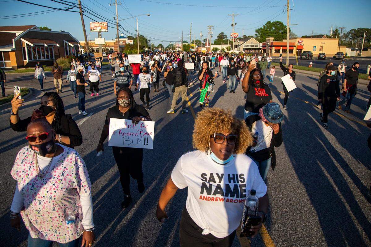 Demonstrators march peacefully in Elizabeth City on Monday April 26, 2021 after family viewed 20 seconds of police body camera video of the shooting death of Andrew Brown Jr. Brown was killed Wednesday by Pasquotank County Sheriff deputies serving a warrant.