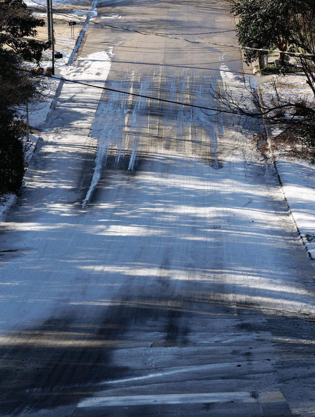 Snow and ice remain on a portion of Churchill Road on Monday, Feb. 2, 2026, in Raleigh, N.C.