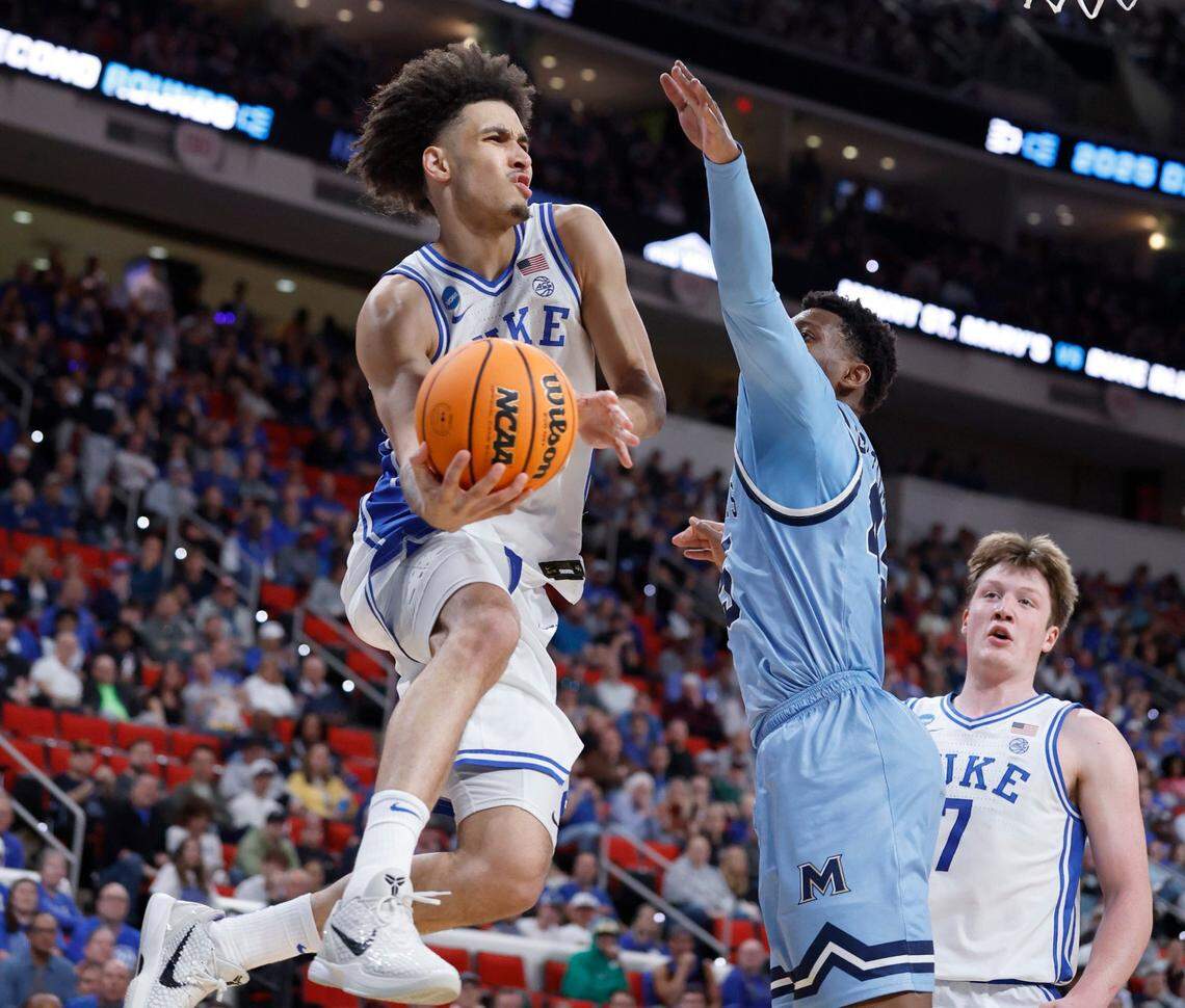Duke’s Tyrese Proctor (5) passes the ball around Mount St. Mary’s Xavier Lipscomb (45) during the second half of Duke’s 93-49 victory over Mount St. Mary’s in the first round of the 2025 NCAA Men’s Basketball Tournament at the Lenovo Center in Raleigh, N.C., Friday, March 21, 2025.