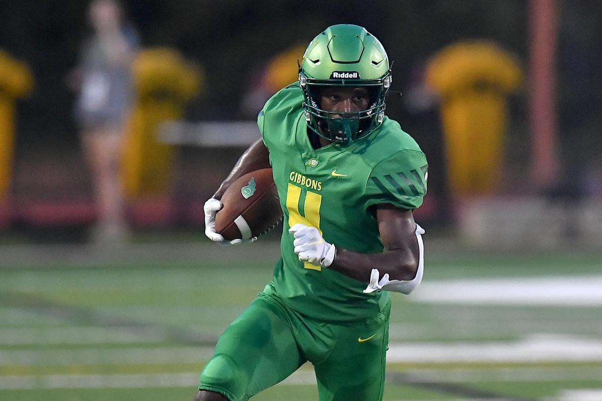 Cardinal Gibbons’ Landon Lawrence (4) runs for yardage against Richmond in the firs t half. The Cardinal Gibbons Crusaders and the Richmond Raiders met in a football game in Raleigh, N.C. on September 2, 2022.