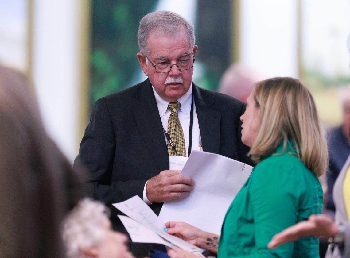 Rep. Donny Lambeth, a Republican from Forsyth, speaks with Rep. Sarah Crawford, prior to a session in the House chamber of the Legislative Building on Wednesday, May 21, 2025, in Raleigh, N.C.