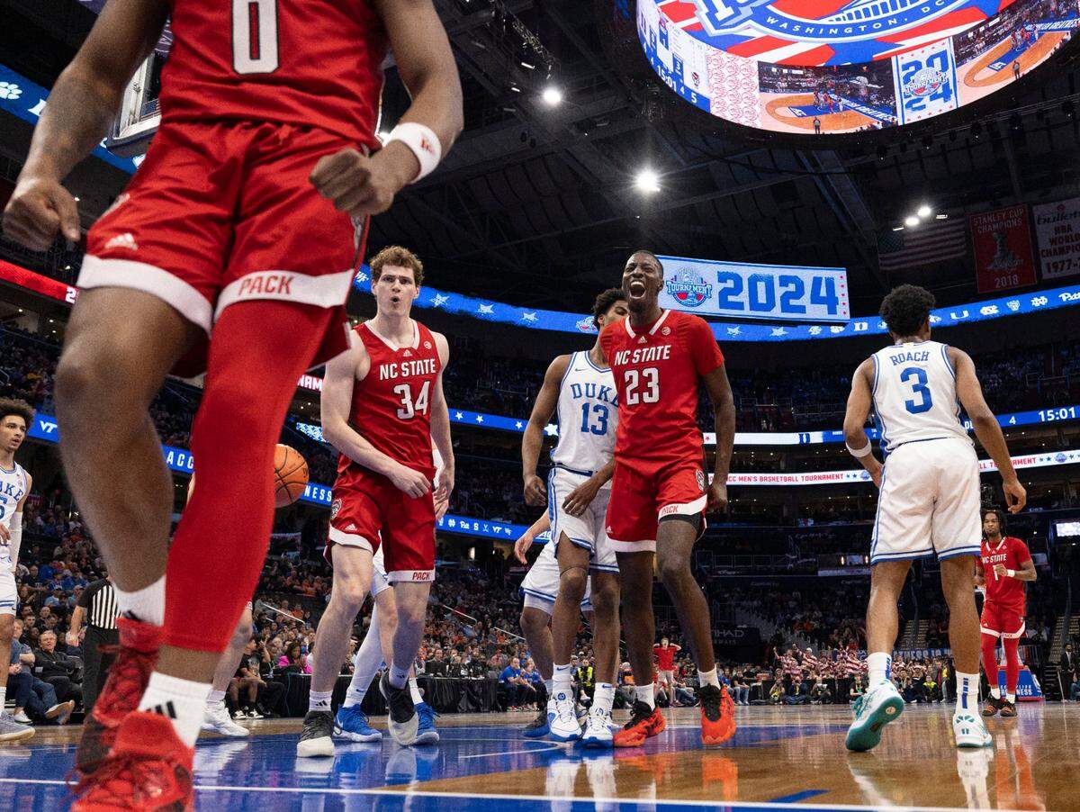 N.C. State’s Mohamed Diarra (23) reacts after teammate  D.J. Horne (0) scored and drew a foul from Duke’s Jared McCain (0) in the first half during the quarterfinals of the ACC Men’s Basketball Tournament at Capitol One Arena on Wednesday, March 13, 2024 in Washington, D.C.