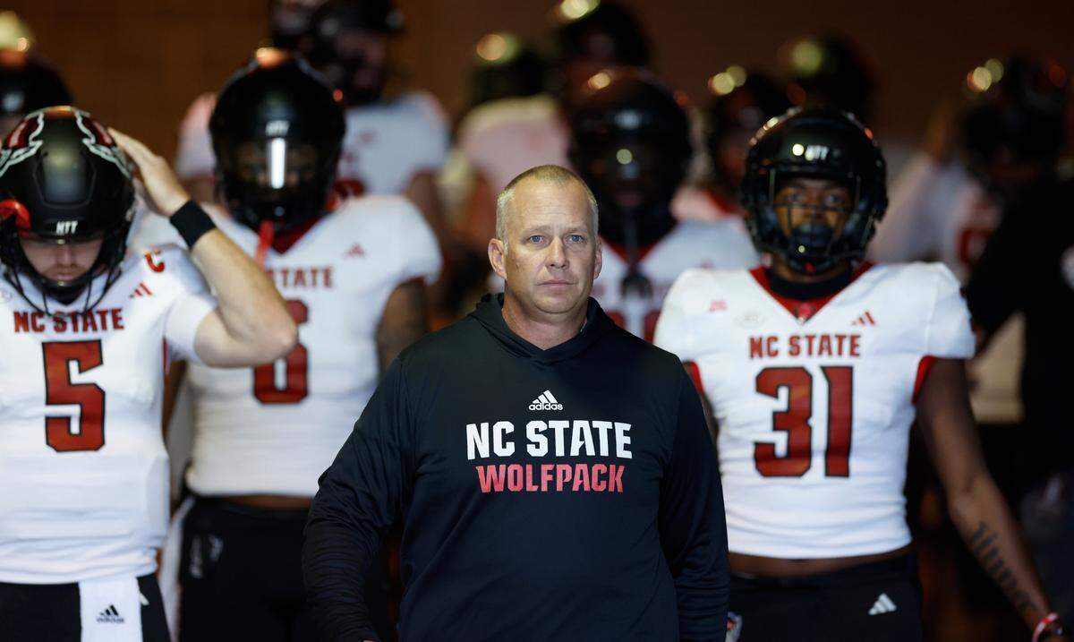 N.C. State head coach Dave Doeren leads his team to the field before the Wolfpack’s game against Virginia Tech at Lane Stadium in Blacksburg, VA, Saturday, Nov. 18, 2023.