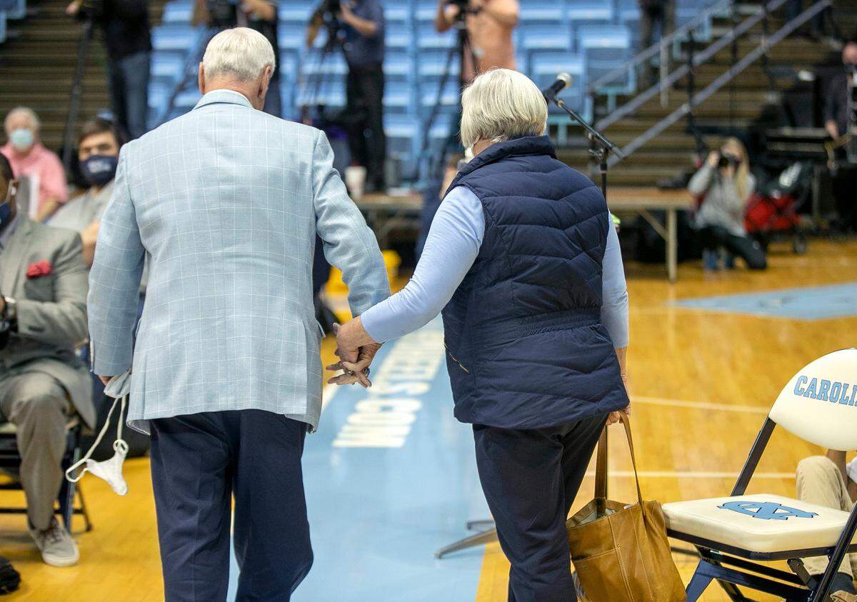 North Carolina coach Roy Williams leaves the Smith Center hand in hand with his wife Wanda, after announcing his retirement from coaching on Thursday, April 1, 2021 at the Smith Center in Chapel Hill, N.C. Williams had coached for 33 seasons, the last 18 at North Carolina, winning the National Championship in 2005, 2009, and 2017.