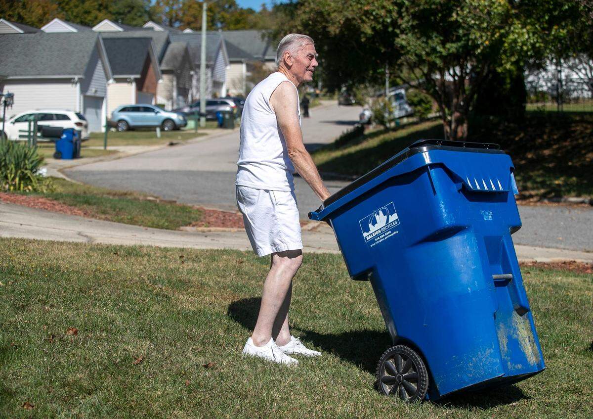 John Bobeng, who lives at the corner of Sahalee Way and Castle Pines Dr., takes in his trash can on Friday, October 14, 2022 in Raleigh, N.C. Bobeng said he was outside yesterday when he hear the gunfire leading to the death of five people in the Hedingham neighborhood, including an off-duty police officer.