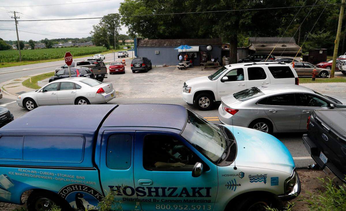 Cars fill the parking lot and park on the side of the road as the lunch crowd picks up at B’s Barbecue in Greenville NC, on June 7, 2017. B’s is an old-time barbecue restaurant that ranks near the best in the state in several surveys.
