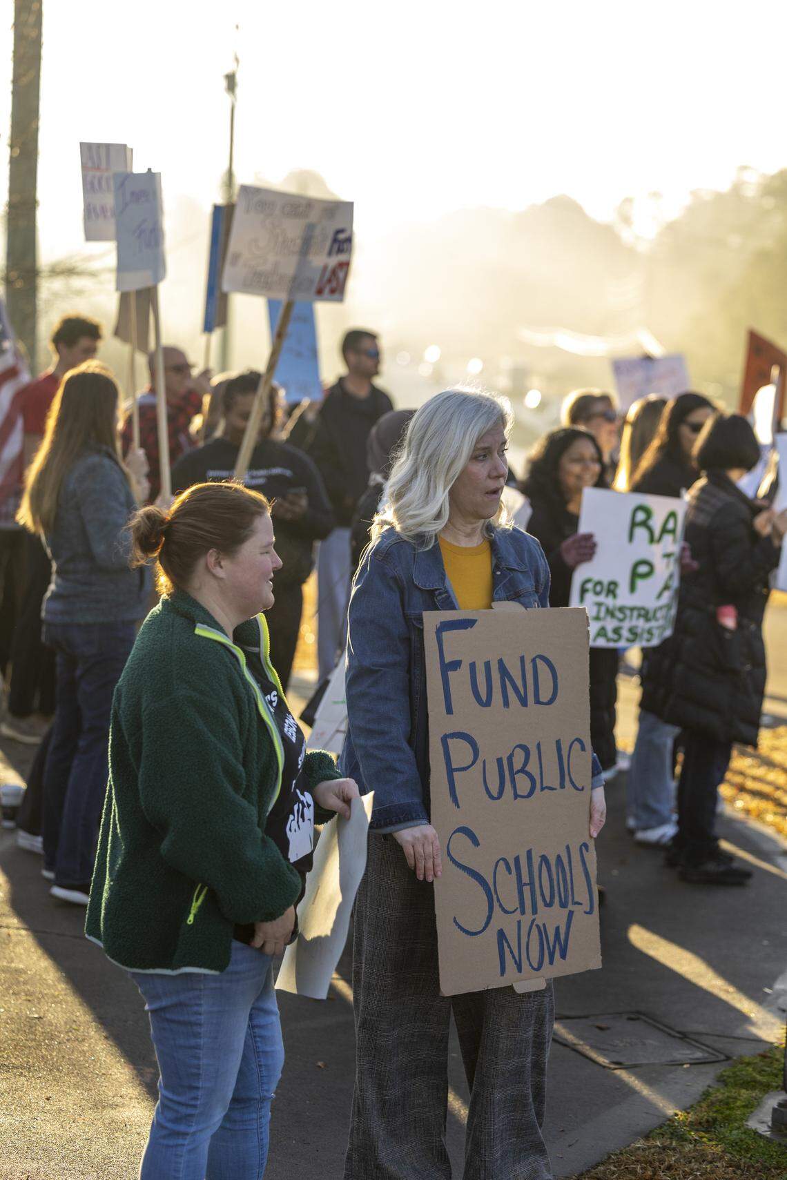 Dozens of educators demonstrate at the intersection of Green Level Church and Carpenter Fire Station roads in Cary on Wednesday morning, Jan. 7, 2026, calling on state lawmakers to provide more funding for public education. Leaders of NC Teachers in Action say 650 to 750 educators from 52 schools, including 30 in Wake County, called out of work Wednesday to participate in the protests.