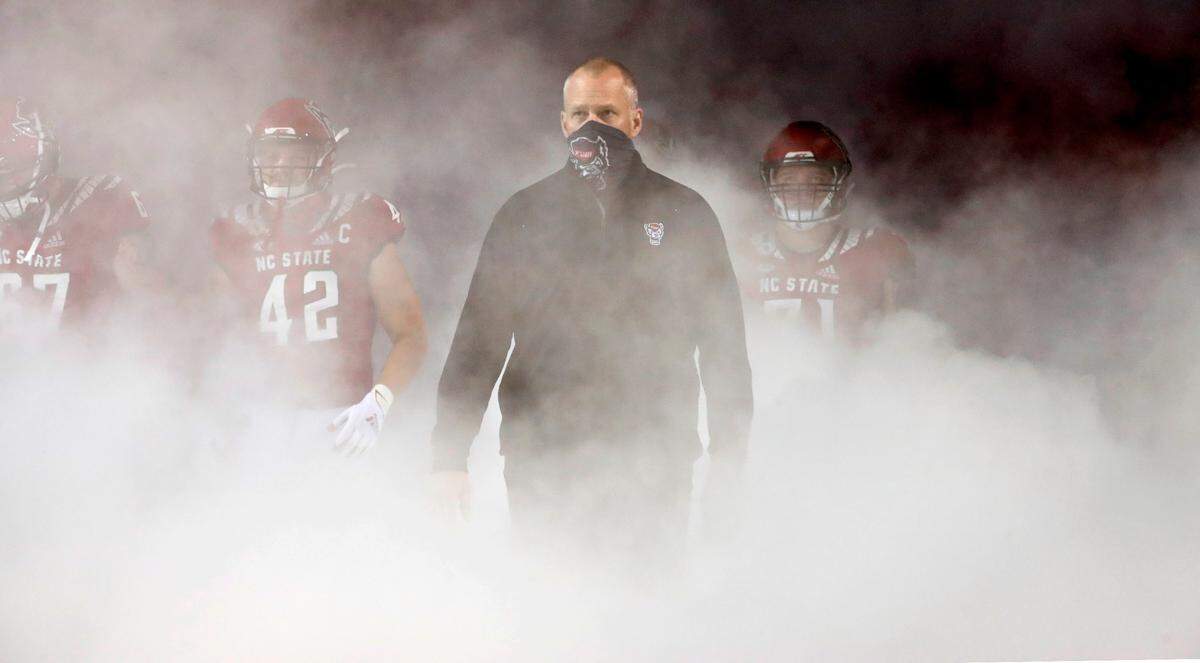 N.C. State head coach Dave Doeren and the team head onto the field before N.C. State’s game against Liberty at Carter-Finley Stadium in Raleigh, N.C., Saturday, Nov. 21, 2020.