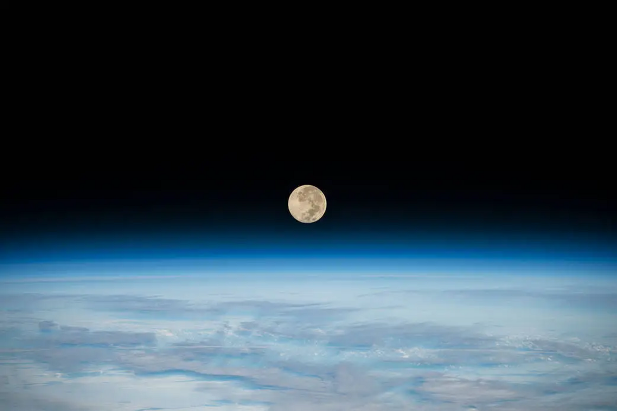 The Full Moon is pictured setting below Earth’s horizon from the International Space Station as it orbited 269 miles above the southern Indian Ocean in December 2022. The next full moon will be June 21. Some call that the Strawberry Moon.