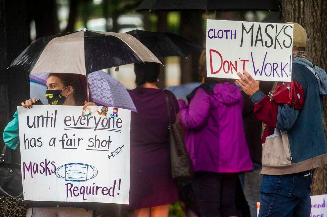 Protesters and counter-protesters demonstrate outside a Wake County Board of Education meeting Tuesday, Aug. 3, 2021 in Cary. The board will vote on a proposal to continue to require face masks in schools. Some parents argue the coverings should be optional.