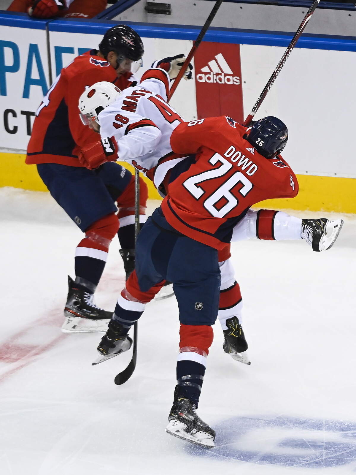 Washington Capitals center Nic Dowd (26) hits Carolina Hurricanes left wing Jordan Martinook (48) during the first period of an exhibition NHL hockey game Wednesday, July 29, 2020 in Toronto. (Nathan Denette/The Canadian Press via AP)