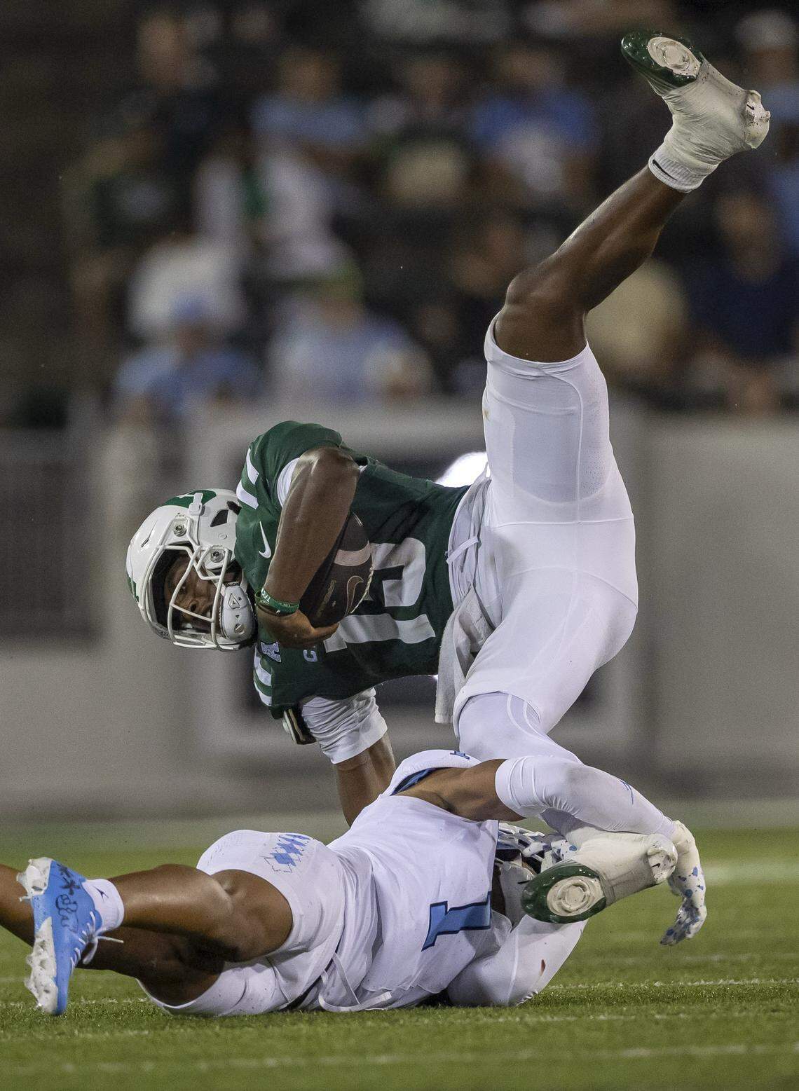 UNC Charlotte quarterback Conner Harrell (15) is stopped by North Carolina defensive back Thaddeus Dixon (1) after an eight yard gain in the fourth quarter on Saturday, September 6, 2025 at Jerry Richardson Stadium in Charlotte, N.C. 