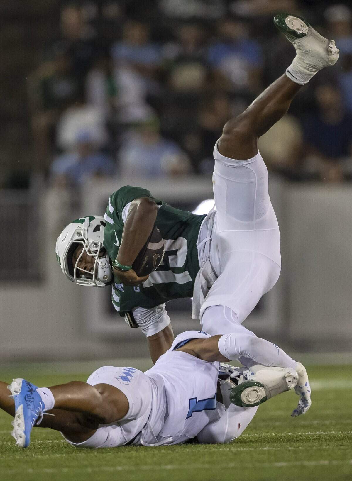 UNC Charlotte quarterback Conner Harrell (15) is stopped by North Carolina defensive back Thaddeus Dixon (1) after an eight yard gain in the fourth quarter on Saturday, September 6, 2025 at Jerry Richardson Stadium in Charlotte, N.C.