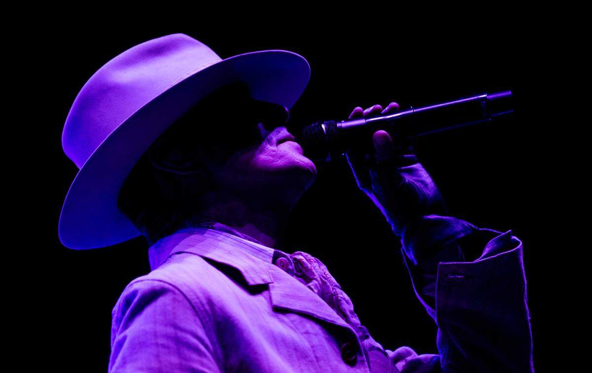 Jane’s Addiction lead singer Perry Farrell opens the show bathed in blue light at Raleigh, N.C.’s Red Hat Amphitheater, Tuesday night, Sept. 3, 2024.