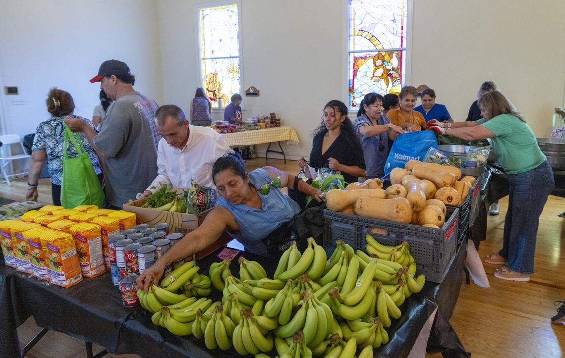 Swannanoa residents receive food aid during a giveaway organized by the Bounty & Soul Free Produce Market at the former Swannanoa United Methodist Church in mid-August. 