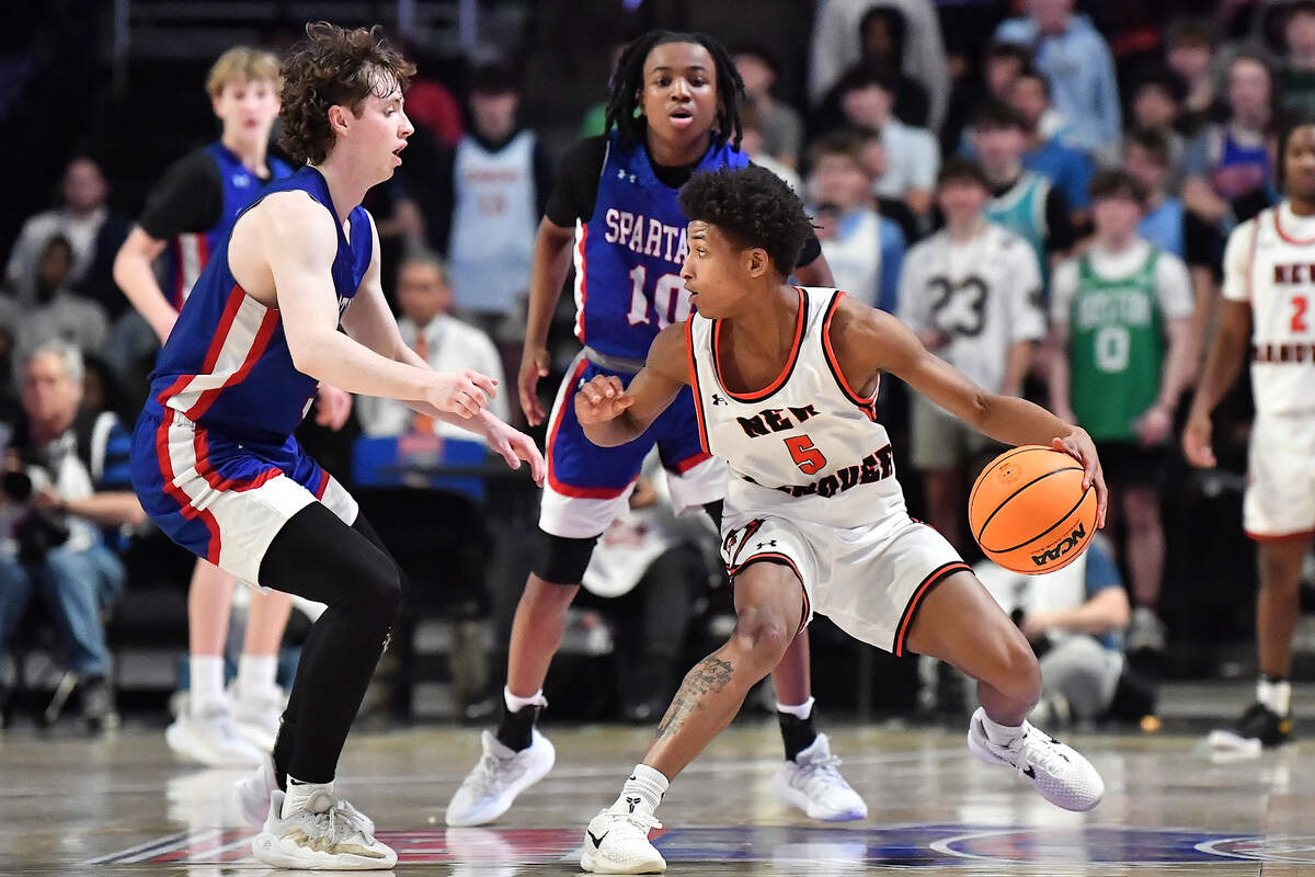 Sanderson’s Nathan Fife (5) and Kendrick Pulley (10) defend New Hanover’s Rodmik Allen (5) during the second half. The Sanderson Spartans and the New Hanover Wildcats met in the NCHSAA 4A East Regional Final in Winston-Salem, N.C. on March 12, 2025.