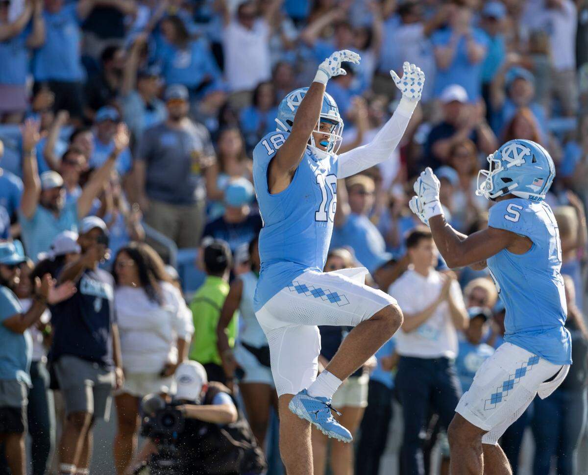 North Carolina’s Bryson Nesbit (18) celebrates with teammate J.J. Jones (5) after scoring a touchdown on a 19-yard pass reception from quarterback Drake Maye to give the Tar Heels a 21-3 lead over Minnesota on Saturday, September 16, 2023 at Kenan Stadium in Chapel Hill N.C.