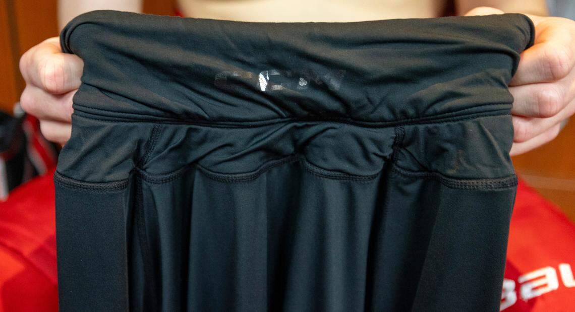 Carolina Hurricanes defenseman Dylan Coghlan (15) displays the high-tech Kevlar undershirt with a collar that he wears to protect his neck from a skate cut following practice on Thursday, May 2, 2024 at PNC Arena in Raleigh, N.C
