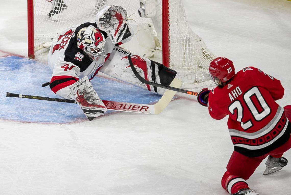 The New Jersey Devils goalie Vivek Vanecek (41) deflects a scoring attempt by the Carolina Hurricanes Sebastian Aho (20) in the second period during Game 1 of their second round Stanley Cup playoff series on Wednesday, May 3, 2023 at PNC Arena in Raleigh, N.C.