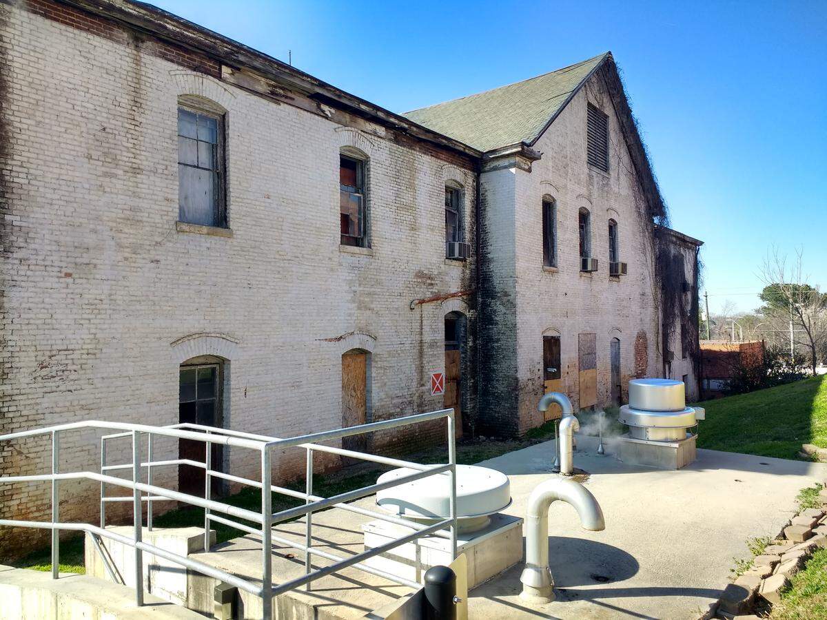 State government will soon demolish three run-down buildings along Dawson Street in downtown Raleigh, including a century-old building that was originally a broom and mattress factory employing students from the state’s school for the blind and deaf, which at the time was located next door. That building was later used as a heating plant for the state government complex. The demolition was approved by the Council of State in March 2019.