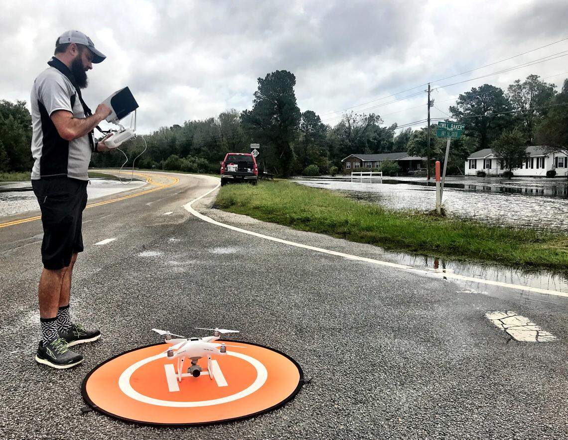 News & Observer veteran photojournalist Travis Long prepares to fly a drone over flooding near Kinston from Hurricane Florence in 2018.