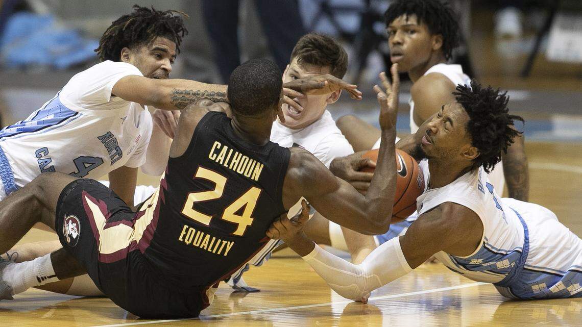 North Carolina’s Leaky Black (1) battles for a loose ball with Florida State’s Sardaar Calhoun (24) during the first half on Saturday, February 27, 2021 in Chapel Hill, N.C.