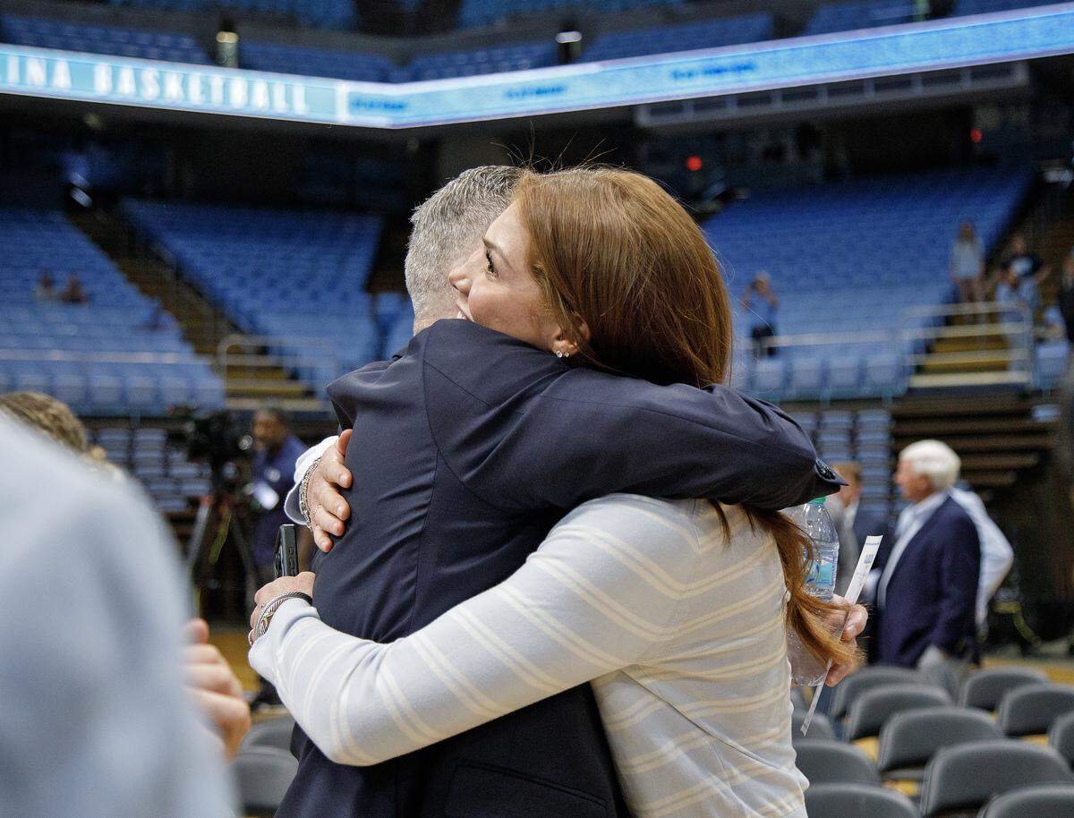 North Carolina volleyball player Bridget Malone smiles she hugs her father, Michael Malone, after he was introduced as the men’s basketball head coach during a press conference at the Smith Center on Tuesday, April 7, 2026, in Chapel Hill, N.C. 