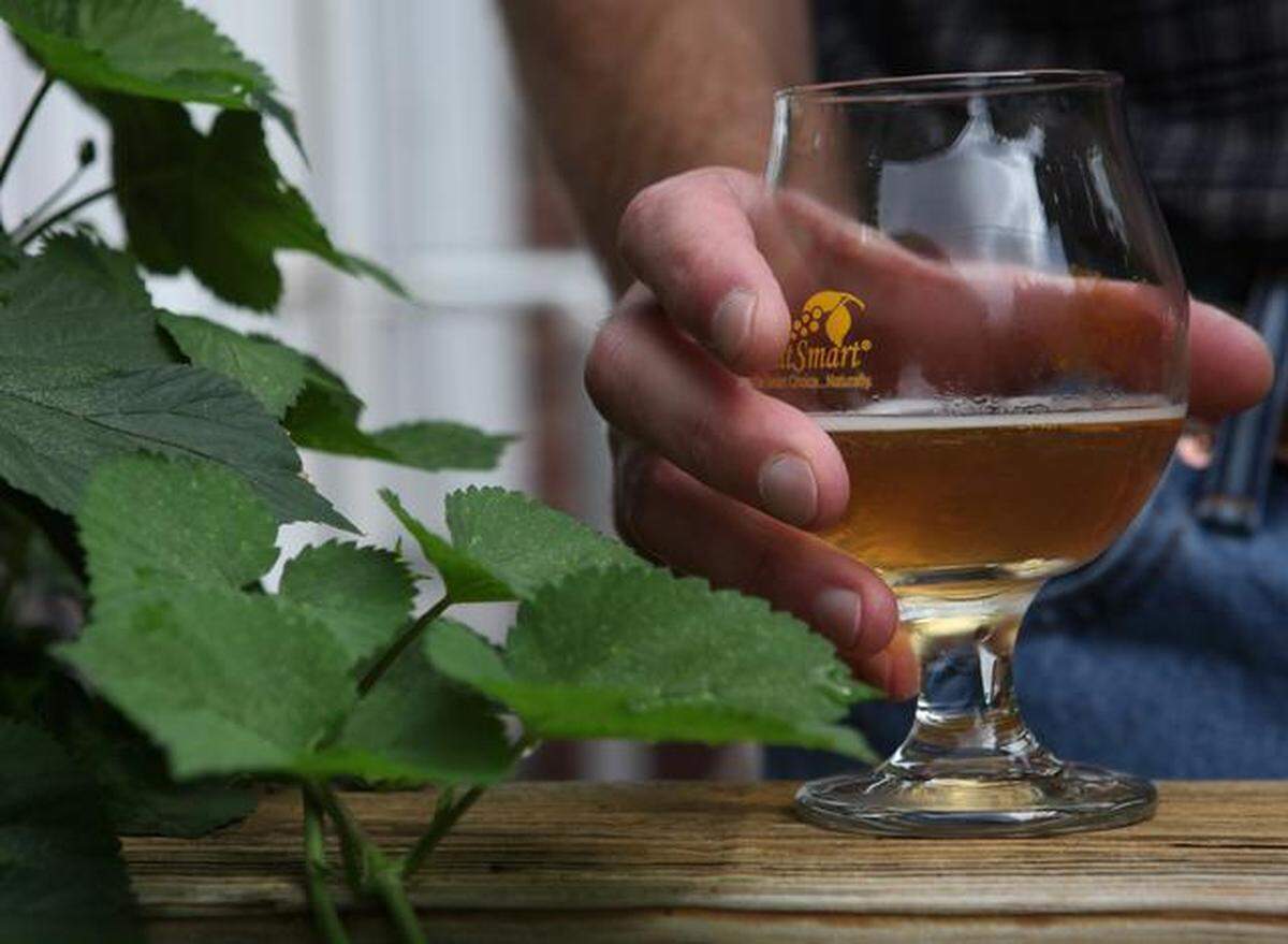 original: Homebrewer Brian Beauchemin, who is launching GoodRoad CiderWorks, holds a glass of his hard cider on the porch of his South Charlotte home. Beauchemin brews from his home while looking for a permanent location for his cidery. 