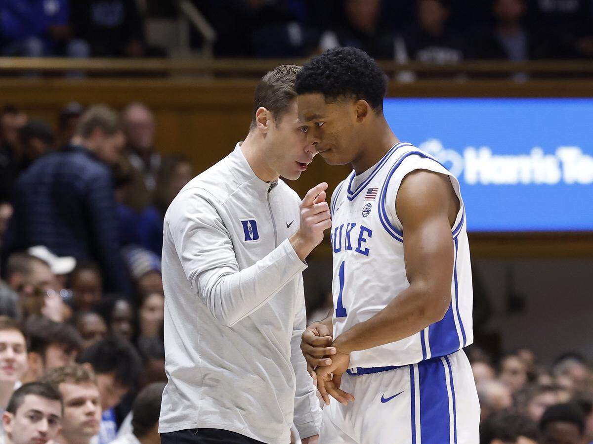 Duke head coach Jon Scheyer talks with Caleb Foster during the first half of the Blue Devils’ game against Lipscomb on Tuesday, Dec. 16, 2025, at Cameron Indoor Stadium in Durham, N.C.