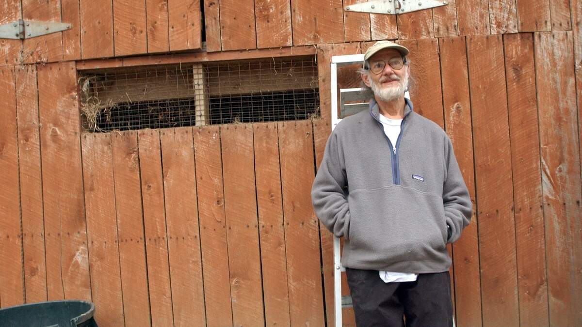 Duke University biology professor Peter Klopfer outside one of his animal barns on family land in Orange County in a 2003 file photo. Klopfer, a civil rights activist and co-founder of the Duke lemur center, has died at age 95. 