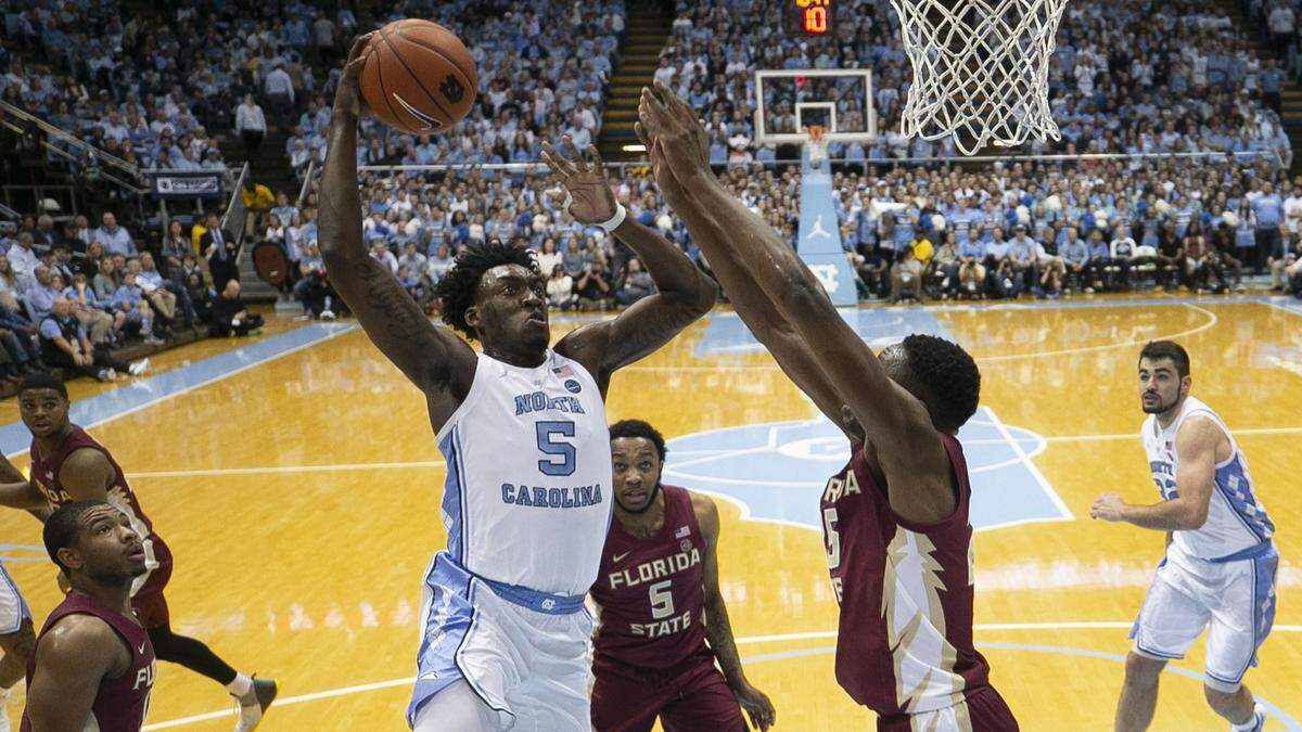 North Carolina’s Nassir Little (5) drives on Florida State’s Mfiondu Kabegnele (25) for a dunk during the first half on Saturday, February 23, 2019 at the Smith Center in Chapel Hill, N.C