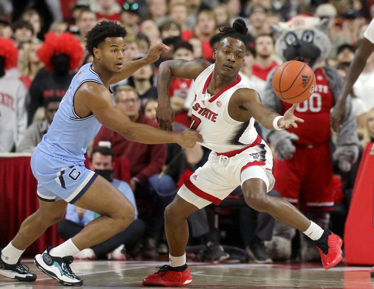 The Citadel’s AJ Smith and N.C. State’s DJ Horne chase after a loose ball during the first half of the Wolfpack’s season opener on Monday, Nov. 6, 2023, at PNC Arena in Raleigh, N.C.