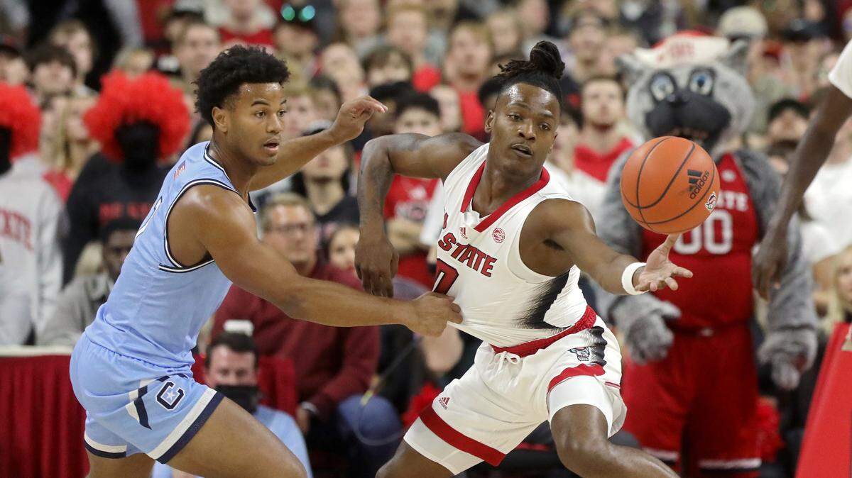 The Citadel’s AJ Smith and N.C. State’s DJ Horne chase after a loose ball during the first half of the Wolfpack’s season opener on Monday, Nov. 6, 2023, at PNC Arena in Raleigh, N.C.