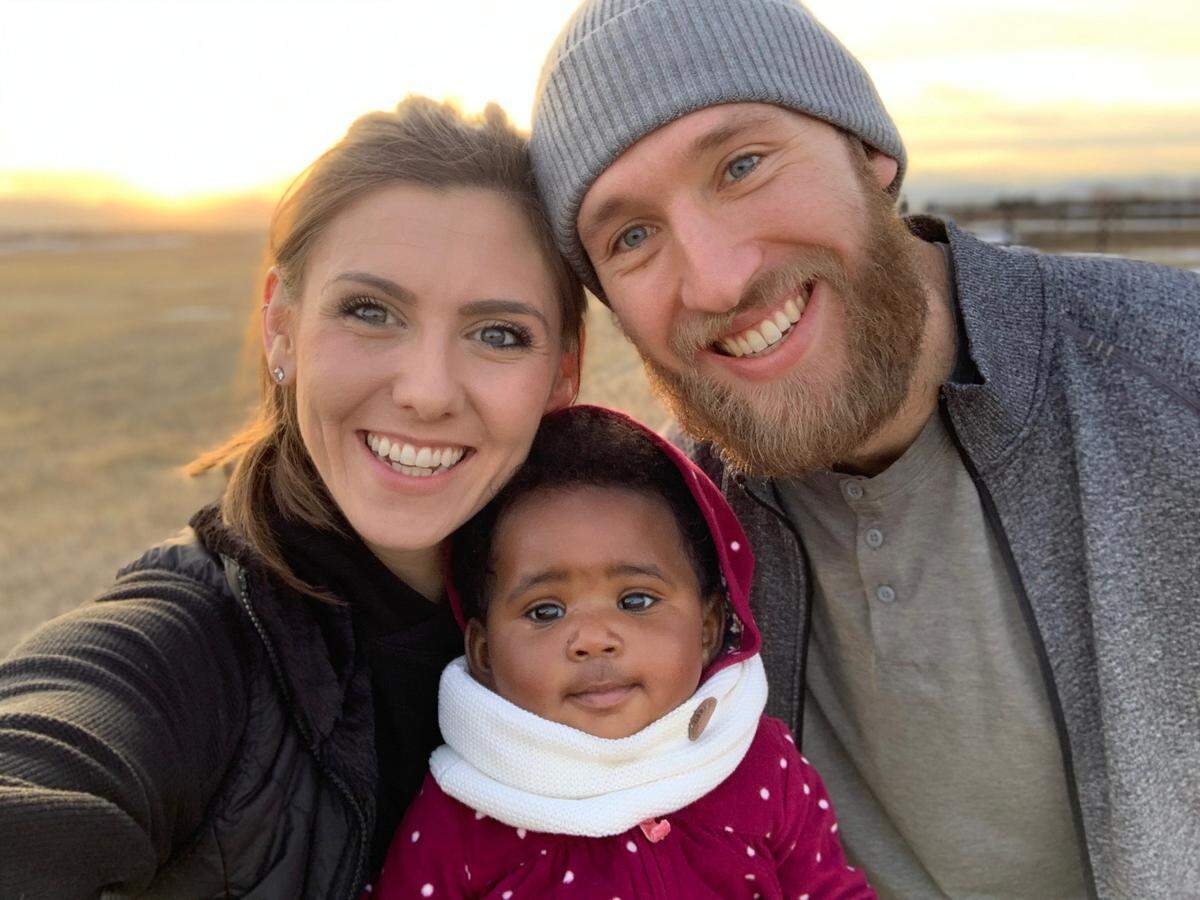 Carolina Hurricanes defenseman Jaccob Slavin, right, and his wife Kylie, left, adopted their daughter Emersyn last year.