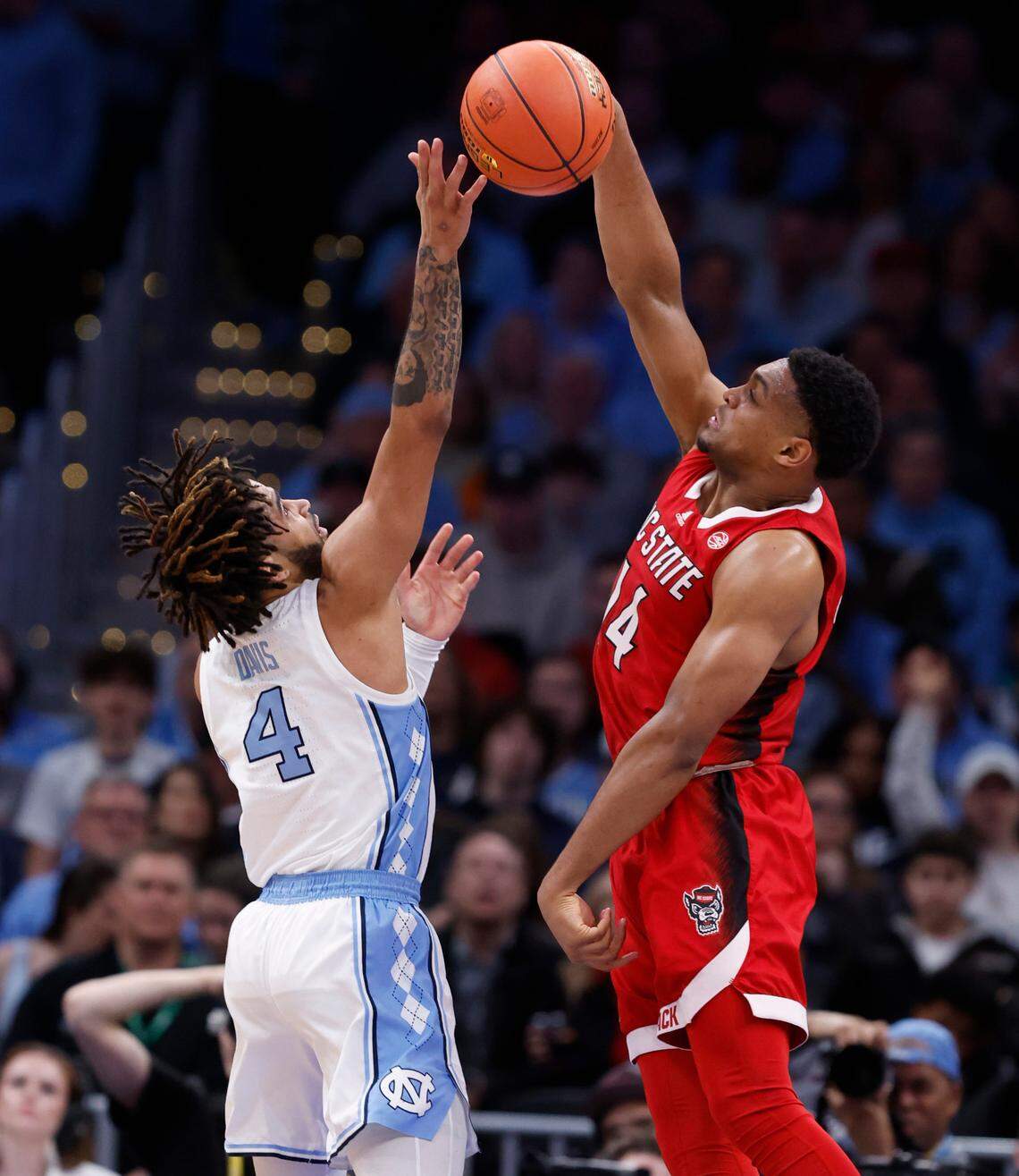 N.C. State’s Casey Morsell (14) blocks the shot by North Carolina’s RJ Davis (4) during the second half N.C. State’s 84-76 victory over UNC in the championship game of the 2024 ACC Men’s Basketball Tournament at Capital One Arena in Washington, D.C., Saturday, March 16, 2024.