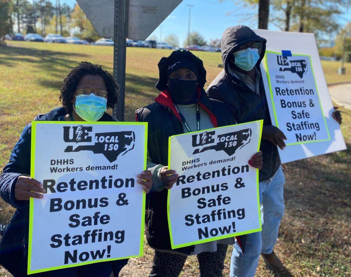 Buba Sabally, right, and other healthcare techs who are N.C. Department of Health and Human Services employees, rallied outside their jobs at Central Regional Hospital in Butner in November 2021.